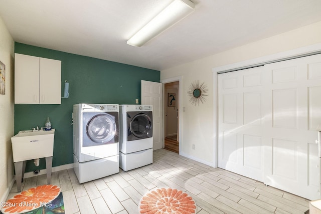 laundry room with cabinets and washing machine and clothes dryer