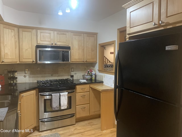 kitchen featuring sink, backsplash, stainless steel appliances, light hardwood / wood-style floors, and light brown cabinets