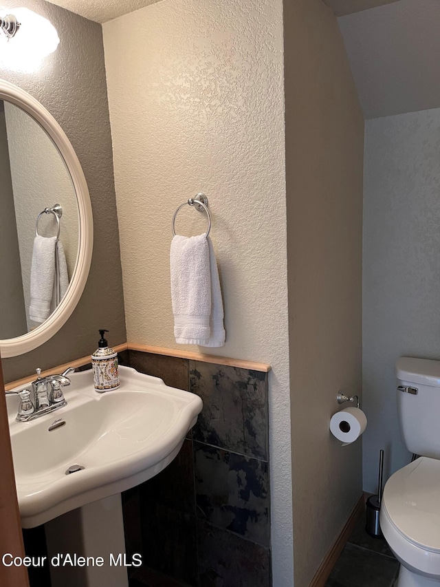 bathroom with tile patterned flooring, sink, and toilet