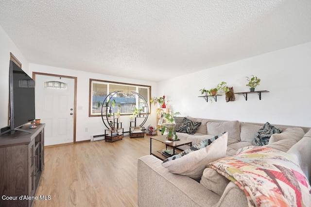 living room with a textured ceiling and light hardwood / wood-style flooring