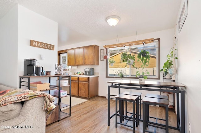 kitchen featuring light hardwood / wood-style floors and a textured ceiling