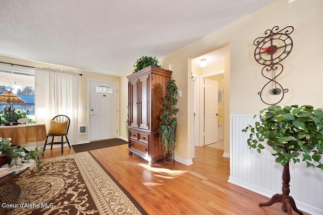 foyer featuring hardwood / wood-style flooring and a textured ceiling