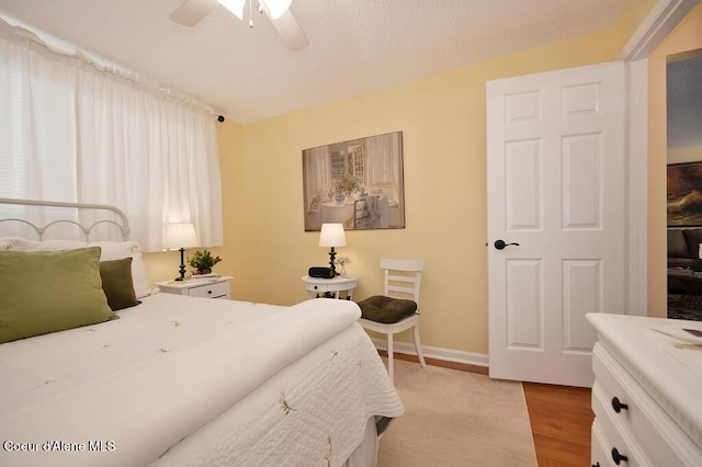 bedroom with ceiling fan and light hardwood / wood-style flooring