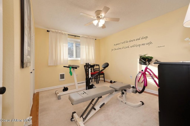 exercise area featuring carpet flooring and ceiling fan