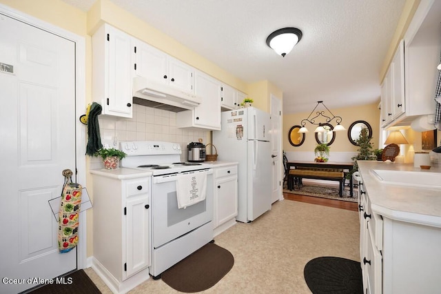 kitchen featuring sink, white cabinets, a notable chandelier, white appliances, and backsplash