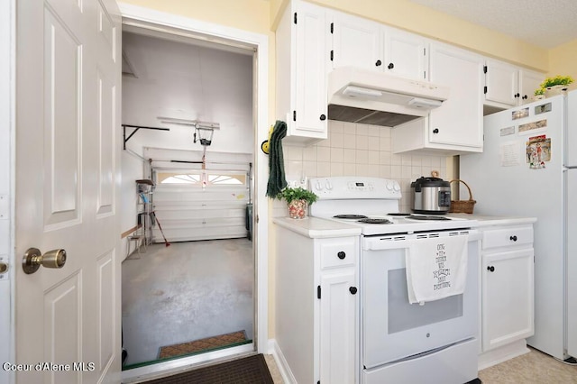 kitchen with backsplash, white appliances, and white cabinets