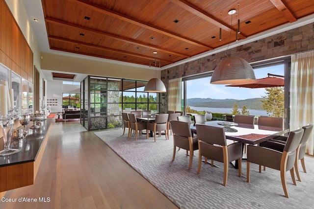 sunroom / solarium featuring beam ceiling, wood ceiling, and a water and mountain view