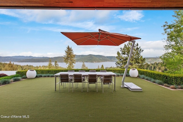 view of patio featuring a water and mountain view