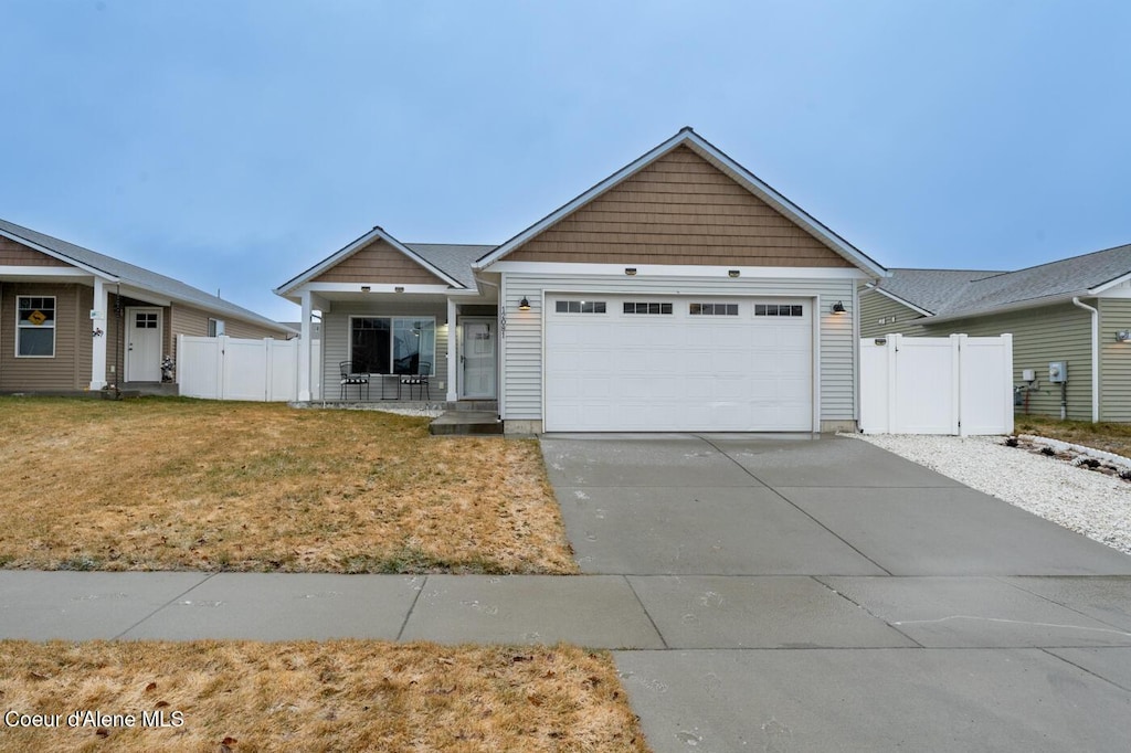 view of front of home featuring a garage and a front lawn