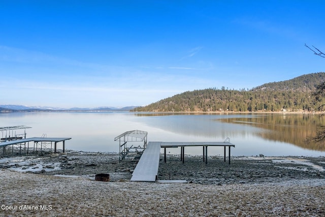 view of dock featuring a water and mountain view