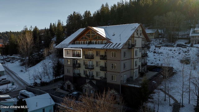 view of snow covered rear of property