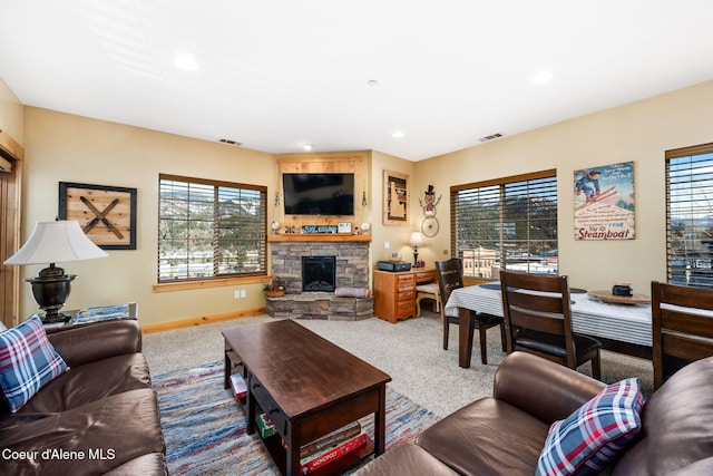 living room featuring carpet flooring and a fireplace