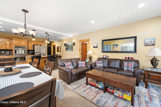 carpeted living room featuring an inviting chandelier