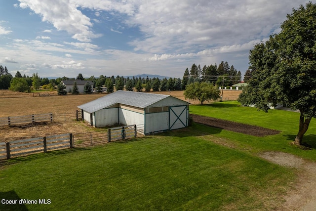 view of yard with an outbuilding and a rural view