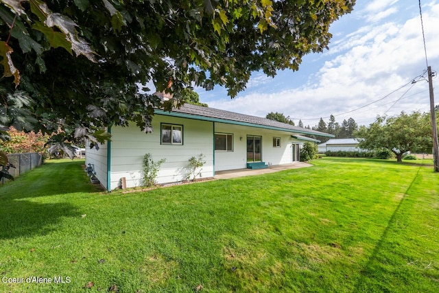 rear view of house with a lawn