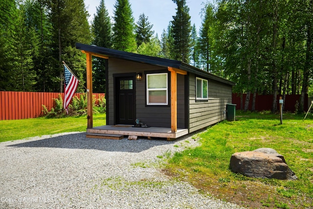 view of outbuilding featuring a lawn