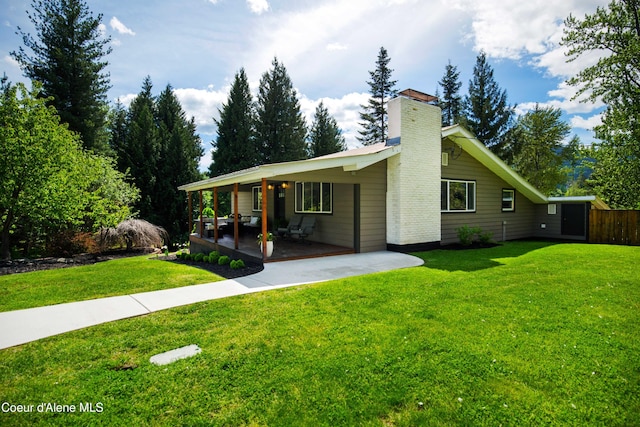 view of front of property featuring a front lawn and a patio area