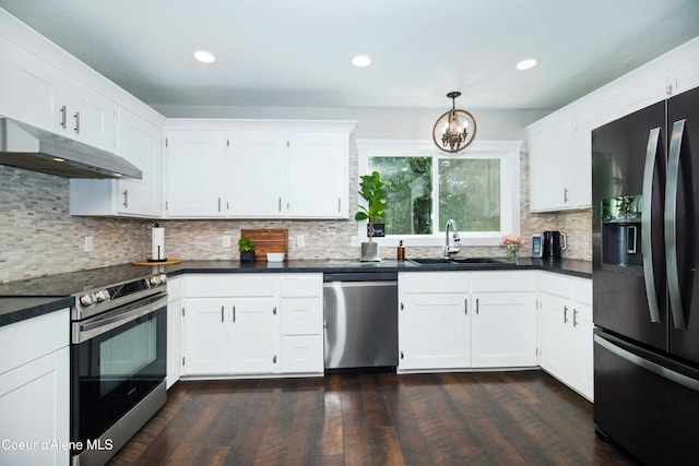 kitchen with appliances with stainless steel finishes, decorative light fixtures, sink, and white cabinets