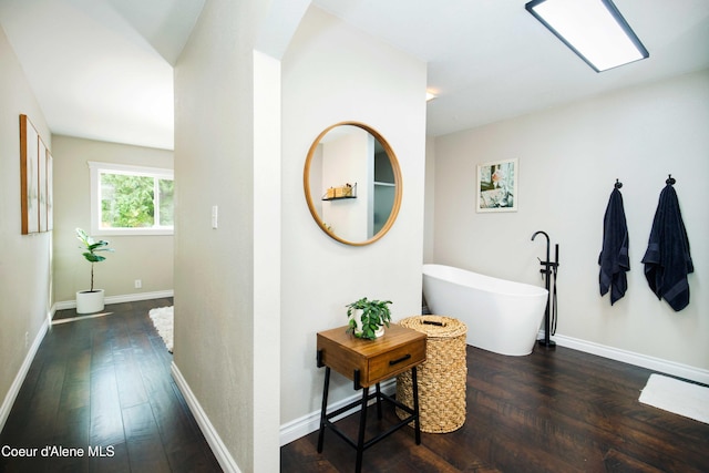 corridor with dark hardwood / wood-style flooring