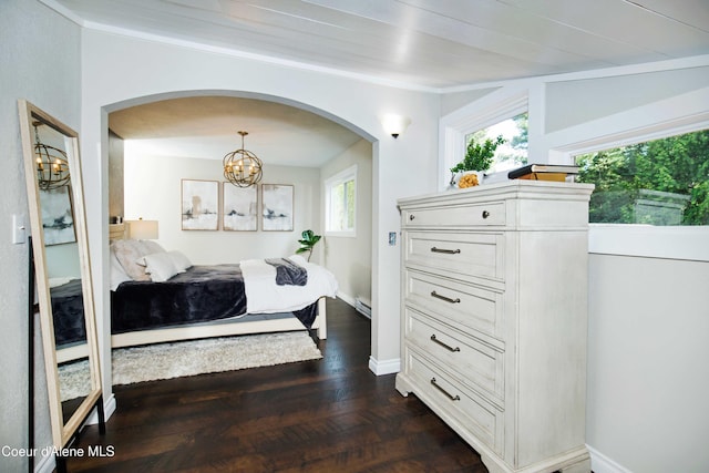 bedroom with an inviting chandelier and dark wood-type flooring