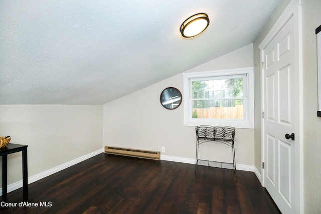 bonus room featuring vaulted ceiling, dark hardwood / wood-style floors, a textured ceiling, and a baseboard heating unit