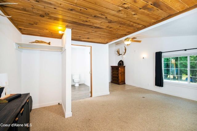 unfurnished bedroom featuring light carpet, connected bathroom, and wooden ceiling