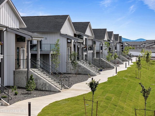 view of community featuring a mountain view and a yard