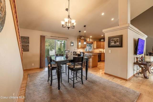 dining area featuring an inviting chandelier and light hardwood / wood-style floors