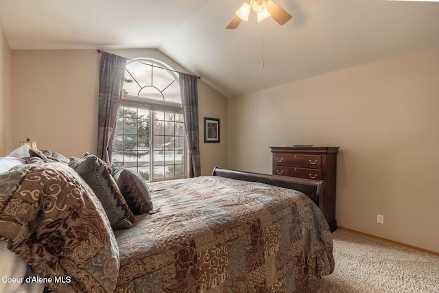 bedroom with ceiling fan, lofted ceiling, and carpet