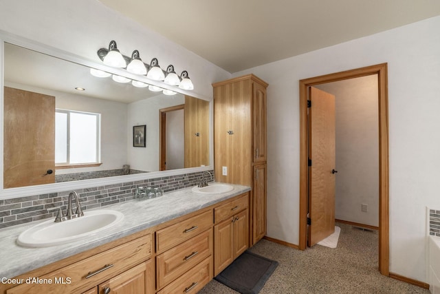 bathroom featuring vanity, backsplash, and a bathing tub