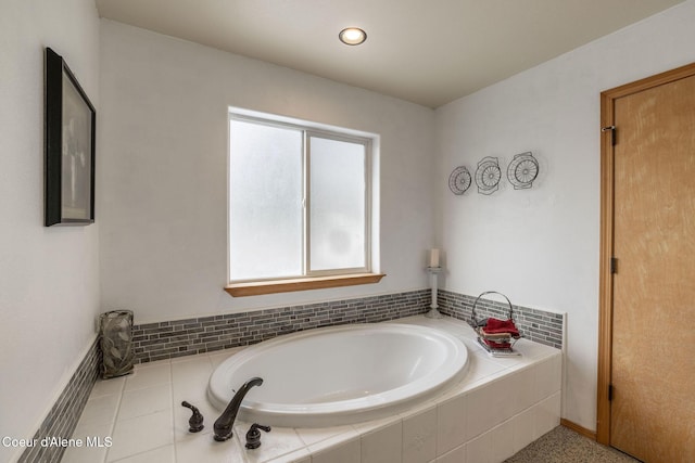 bathroom featuring tiled tub