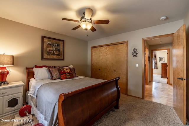 carpeted bedroom featuring a closet and ceiling fan