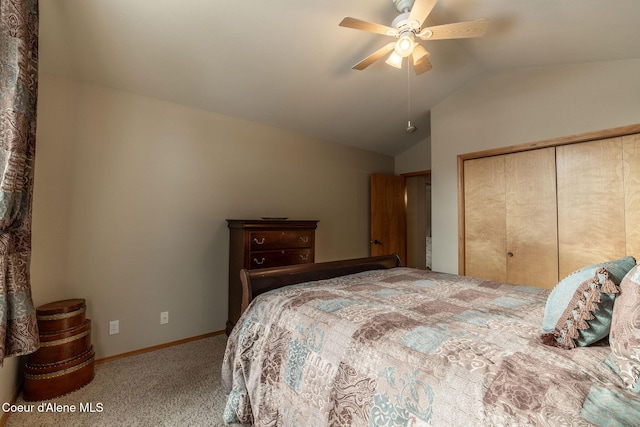 bedroom with carpet floors, vaulted ceiling, a closet, and ceiling fan