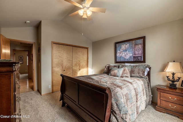 bedroom with lofted ceiling, light carpet, a closet, and ceiling fan