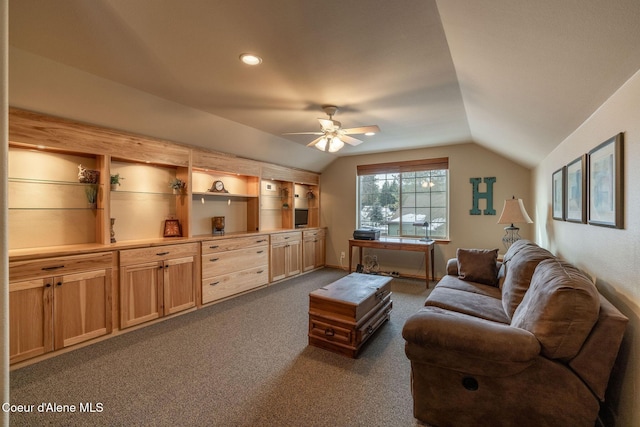 living room with dark colored carpet, lofted ceiling, and ceiling fan