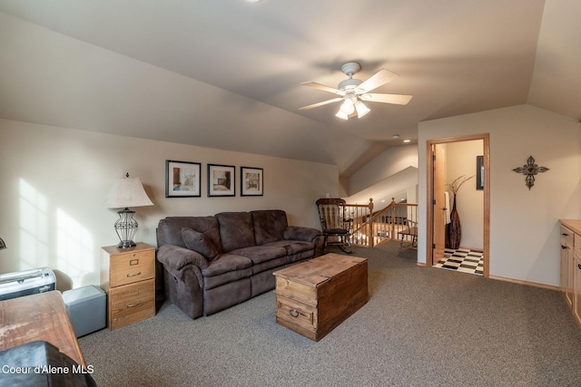 carpeted living room with ceiling fan and vaulted ceiling