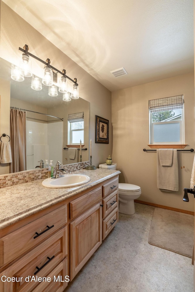 bathroom with vanity, toilet, and a shower with shower curtain