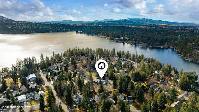 aerial view featuring a water and mountain view