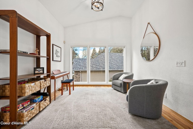 sitting room featuring lofted ceiling and carpet floors