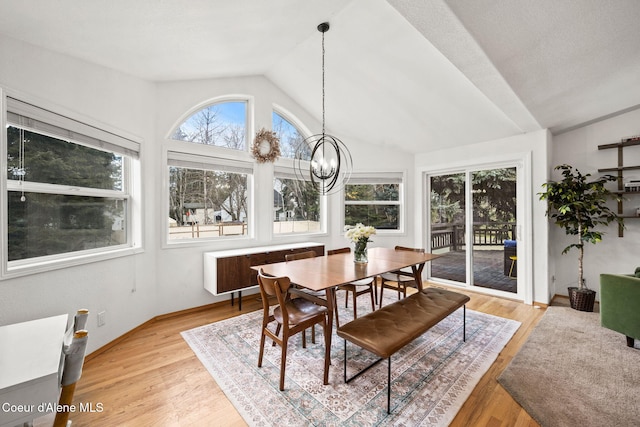 sunroom with vaulted ceiling, a chandelier, and a healthy amount of sunlight