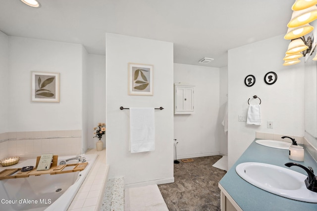 bathroom featuring vanity and a relaxing tiled tub