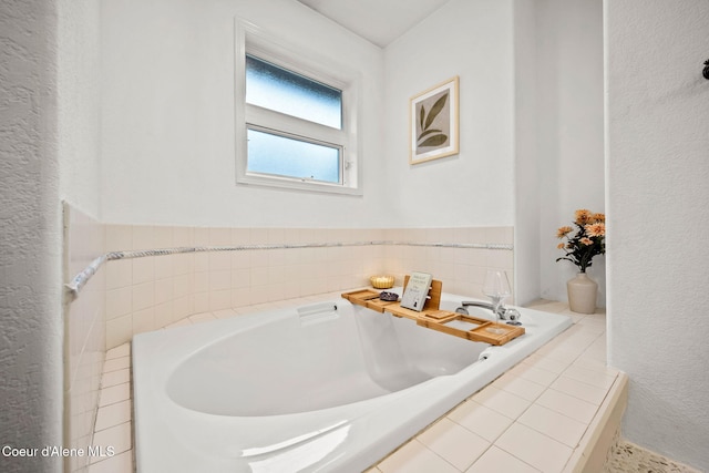 bathroom with a relaxing tiled tub