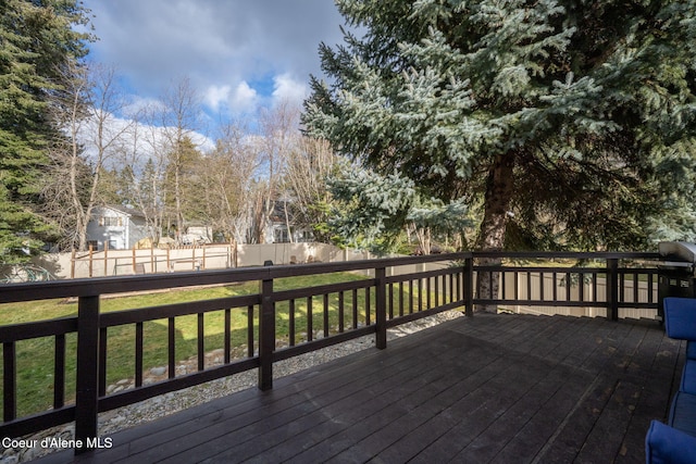 wooden terrace with a lawn