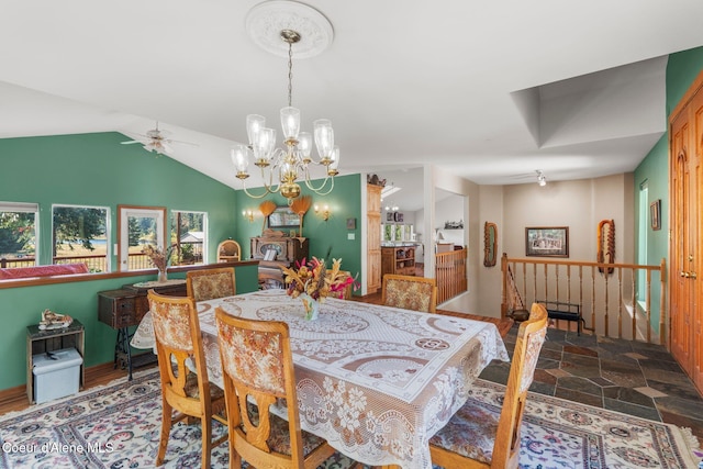 dining room with ceiling fan with notable chandelier and vaulted ceiling