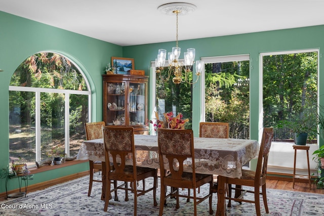 dining area featuring an inviting chandelier and hardwood / wood-style floors