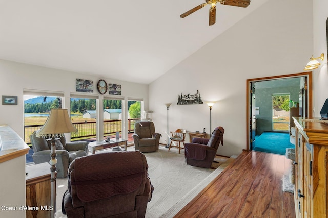 living room with high vaulted ceiling, light hardwood / wood-style floors, and ceiling fan