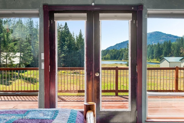 doorway to outside with a water and mountain view