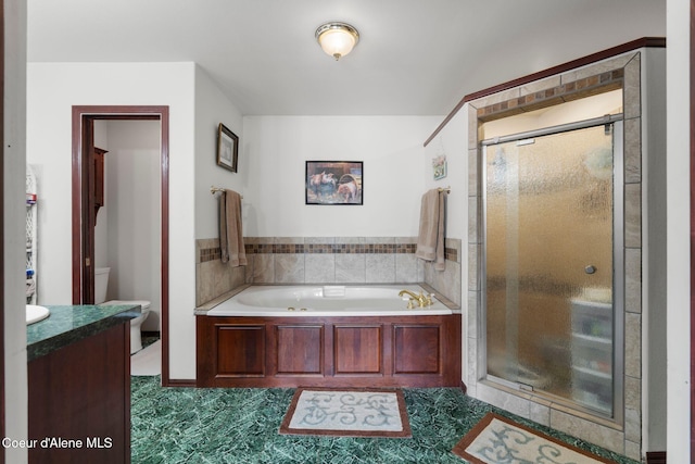 full bathroom with vanity, toilet, and separate shower and tub