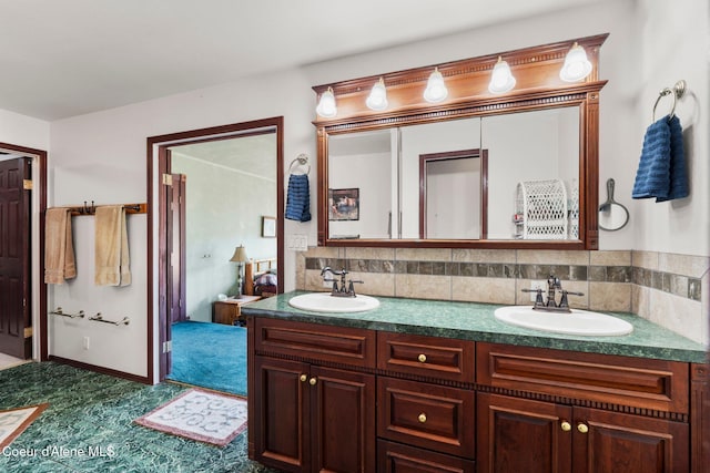 bathroom with tasteful backsplash and vanity