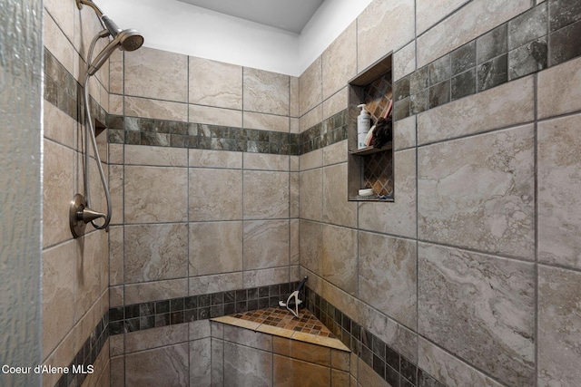 bathroom with a tile shower